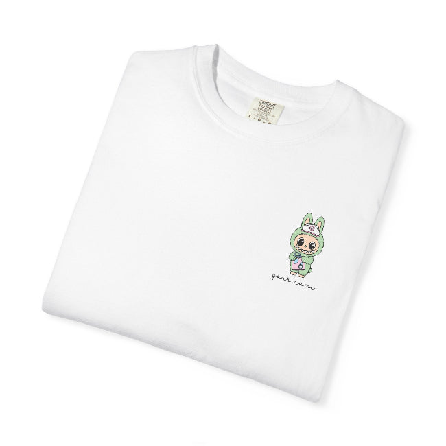 White t-shirt with a small green graphic on a white background