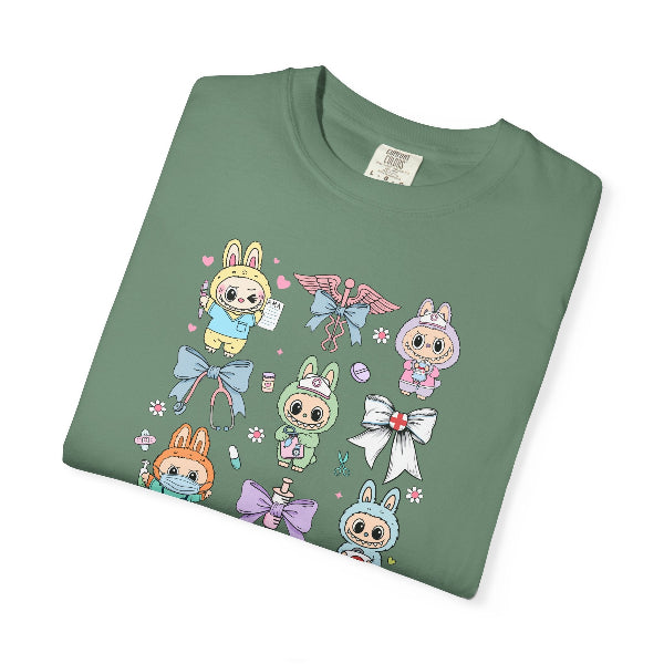 Folded green t-shirt with labubu cartoon character and bow design on a white background