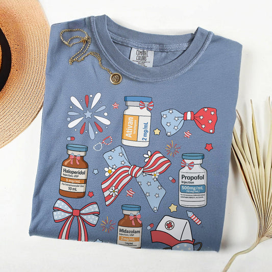 Blue t-shirt with medical-themed graphics and a straw hat on a white background