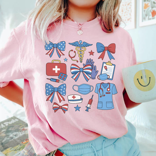 Person wearing a pink t-shirt with medical-themed graphics, holding a mug with a smiley face design.