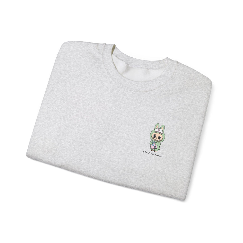 Folded gray sweatshirt with a small green graphic on a white background