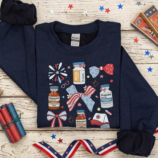 Navy blue sweatshirt with patriotic design on a wooden surface with decorative items.