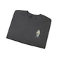Folded dark gray t-shirt with a small embroidered design on a white background