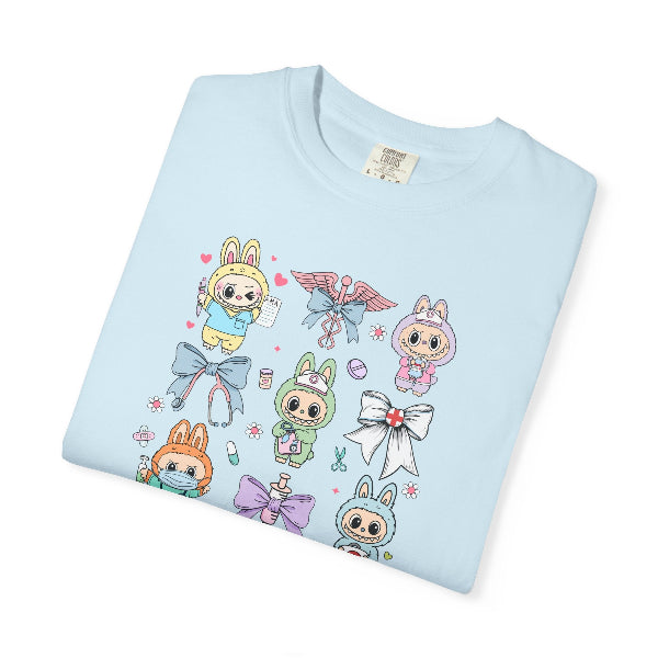 Folded light blue t-shirt with labubu nurse cartoon characters and bows design on a white background